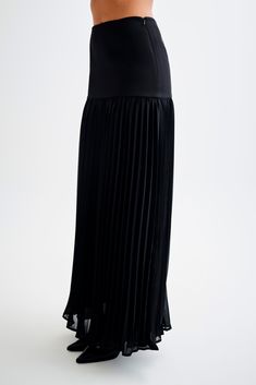 Going with the flow.The JILLIAN Pleated Maxi Skirt is a sophisticated and elegant addition to any wardrobe. This high-waisted skirt features a fitted yoke that transitions into a beautifully pleated chiffon lower skirt, offering a graceful flow and movement. With its maxi length, it exudes timeless charm. Pair it with the Letitia Suiting Halter Top with Buckle for a chic and polished ensemble. Chic Maxi Skirt With Pleated Hem, Full Pleated Skirt With Accordion Pleats For Night Out, Chic Tulle Maxi Skirt, Pleated Maxi Skirt For Spring Evening, Flowy Midi Pleated Skirt For Night Out, Spring Evening Pleated Maxi Skirt, Elegant Tiered Maxi Skirt With Relaxed Fit, Elegant Relaxed Tiered Maxi Skirt, Party Maxi Skirt With Accordion Pleats