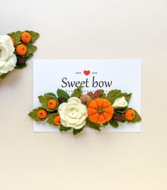 two white and orange flowers are on top of a card that says, sweet bow