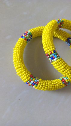 Beaded Bracelets | African Maasai Beaded Bracelets | African Jewelry | Beaded Bangles | Ethnic Bracelets| Gift For Her |A Set Of Two Bangles These superbly crafted beaded bracelets are made of glass beads. The price is for a set of two bracelets. Main Color - Yellow. Available in different colors. Feel free to send me a convo or e-mail for any clarification. Thank you for visiting... African Beaded Bracelets, Beaded Bangles, Yellow Necklace, Bead Bangles, Jewelry Beaded, Maasai, African Beads, African Jewelry, Bracelet Gift