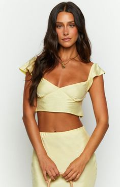 * Yellow Crop Top 
 * Look super feminine and chic in the Anna two piece set (). Gold jewellery () compliments this yellow so well! Utilise the top for a more casual occasion and pair with denim ().  
 * 
 
 * Short sleeves 
 * Cropped length 
 * Invisible zipper (left side) 
 * Seam under bust 
 * Elasticated straps 
 * Tie up back 
 * Non stretch material 
 * Unlined  
 * Slightly sheer Prom Midi Dress, Summer Playsuit, Yellow Crop Top, Beginning Boutique, Strapless Tops, Yellow Top, Crop Top Sweater, Denim Short, One Shoulder Tops