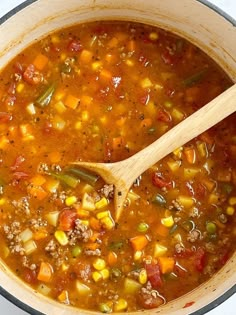 a pot filled with soup and a wooden spoon