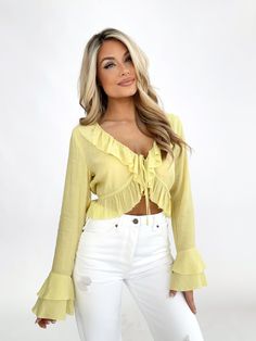 Indulge in the luxurious elegance of our Striking Essence Top. Featuring a flattering v neckline, delicate front tie, and cascading ruffled details, this cropped top is perfect for making a statement. The bold and bright color, with textured fabric and flared sleeves, exudes an elevated and trendy style. Stay comfortable and chic this spring and summer, whether for a dinner, drinks, or vacation. Shell 75% Rayon 25% Polyester Hand wash cold. Dinner Drinks, Trendy Style, Girly Outfits, Textured Fabric, Cropped Top, Bright Color, Flared Sleeves, Trendy Fashion, Essence