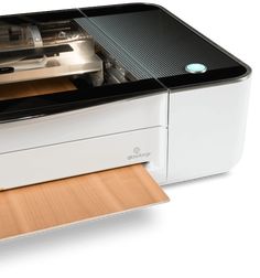 a white and black printer sitting on top of a wooden table