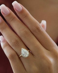 a woman's hand with a diamond ring on it