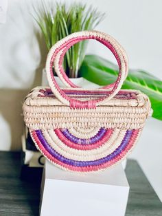 The Ọnwa Raffia Handbag – House of Okara Chic Multicolor Bucket Straw Bag, Multicolor Straw Bag With Bamboo Handle For Vacation, Multicolor Straw Shoulder Bag For The Market, Chic Multicolor Handmade Straw Bag, Multicolor Straw Tote Bag With Bamboo Handle, Pink Rectangular Shoulder Bag With Bamboo Handle, Chic Multicolor Handwoven Shoulder Bag, Multicolor Straw Bag With Bamboo Handle For Everyday, Chic Multicolor Straw Bag With Braided Handles