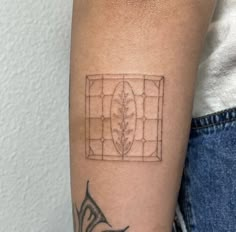 a person with a tattoo on their arm that has an image of a window in it