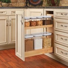 an open cabinet in a kitchen filled with lots of cupboard space and food items on the shelves