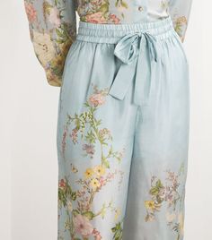 Find ZIMMERMANN Silk Floral Waverly Wide-leg Trousers on Editorialist. Zimmermann always likes to breathe life into its designs. With the Waverly trousers, the Australian label translates blossoming florals and fluttering butterflies onto the soft silk fabric, in an elegant ode to the beauty of summers nature. Light Blue Trousers For Spring, Light Blue Tapered Leg Pants For Spring, Spring Light Blue Trousers, Blue Ankle-length Daywear Bottoms, Blue Ankle-length Daywear Pants, Ankle-length Blue Daywear Pants, Blue Ankle-length Pants For Daywear, Light Blue Bottoms With Elastic Waistband For Spring, Spring Blue Wide Leg Pants For Loungewear