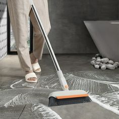 a woman is cleaning the floor with a mop