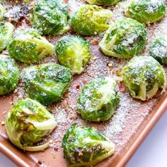 brussel sprouts covered in powdered sugar on a baking sheet, ready to be eaten