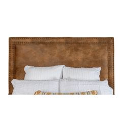 an upholstered headboard with white pillows