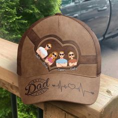 This classic cap is a quintessential accessory for any dad, especially as a Father's Day gift. It boasts a "Best Dad Ever" inscription alongside a heart rate graphic, symbolizing the love and vitality he brings to the family. The cap's unique feature is the personalized section above the visor, where caricatures of children's faces can be placed, each labeled with their names. It's a fashionable and practical way for any father to show off his pride and joy while keeping cool in the sun. MESSAGE Brown Flat Bill Baseball Cap For Gift, Casual Trucker Hat For Father's Day, Curved Brim Baseball Cap For Father's Day, Personalized Baseball Cap For Father's Day, Personalized Curved Brim Baseball Cap For Father's Day, Father's Day Gift Baseball Cap With Curved Brim, Father's Day Gift Trucker Hat With Curved Brim, Father's Day Gift Snapback Hat With Curved Brim, Personalized Hats For Father's Day