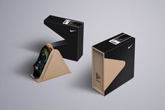 an open cardboard box with a pair of scissors in it next to a folded piece of paper