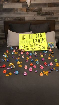 a bed topped with lots of colorful buttons next to a sign that says i'd be on duck