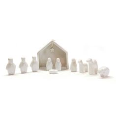 a nativity scene with white ceramic figurines and a star on the top