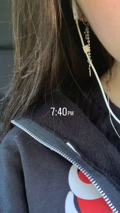 a close up of a person wearing ear wires with the length of their ear hanging down