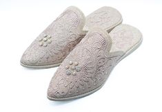 Add a touch of glamour to your wardrobe with our Moroccan Babouche Slippers made in golden silk with beaded pearls. Our skilled artisans handcrafted these luxurious slippers in Morocco and feature intricate embroidery and beadwork for a truly unique and eye-catching design. The golden silk material and beaded pearls make these slippers perfect for special occasions, such as a wedding or bridal shower. They also make for an exquisite bridal gift or a stylish addition to your bridal trousseau. Not only are these embroidered mules stylish, they are also comfortable and practical. The leather sole provides traction and stability, making them perfect for indoor and outdoor wear. Whether you're lounging at home or running errands, these Moroccan Babouche Slippers will keep your feet comfortable Elegant Beige Flat Heel Slippers, Elegant Beige Round Toe Slippers, Elegant Cream Slip-on Mules, Elegant Embroidered Slip-on Wedding Shoes, Wedding Moccasins, Slippers Embroidered, Embroidered Mules, Silk Slippers, Bridal Trousseau