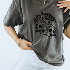 Get ready to be OBSESSED with your new retro halloween cherry shirt. It's the cutest and most trendy way to combine all those important trendy skull cherries shirt vibes! This is the perfect halloween crewneck!  * Q U I C K * F A C T S * ✺  All shirts are UNISEX ✺  100%  ringspun cotton (fiber content may vary for different colors) ✺  Soft-washed, garment-dyed fabric brings extra coziness ✺  Wash and dry normally (on cool for best results) ✺  Sewn-in twill label * S I Z I N G * ✺ For an oversized fit, select two or three sizes up from your normal size ✺ Model is wearing size L  ✺ Sizing runs true to size ✺ Relaxed fit ✺ Most women find their typical size works best, since they are meant to fit a touch loose ✺ See Size guide and fit in images          * S H I P P I N G * T I M E S * ✺ Our i Trendy Skull Shaped Tops For Fall, Trendy Skull Tops For Halloween, Trendy Skull Shaped Tops For Halloween, Relaxed Fit Skull Print Top For Halloween, Edgy Cotton Tops With Skull Print, Edgy Cotton Tops For Halloween, Crew Neck Tops With Cherry Print For Streetwear, Trendy Cotton Skull Print Tops, Cherry Print Crew Neck Top For Streetwear