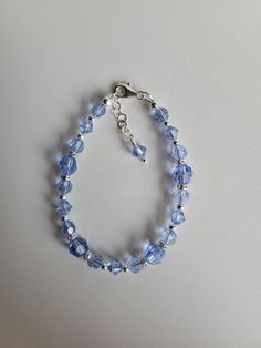 "This blue bracelet is made with 6mm/8mm round and 6mm bicone Swarovski Lt Sapphire crystal 5mm Clear AB rondelle Swarovski crystal. The remainder of the beads and the findings are sterling silver. This bracelet has a 1\" extension with a beaded drop making it adjustable. Custom Orders are always welcome! Ask about free sizing." Blue Crystal Bracelet With Faceted Beads, Blue Faceted Crystal Bracelets, Adjustable Faceted Blue Crystal Bracelet, Blue Faceted Beaded Bracelets, Blue Adjustable Rondelle Crystal Bracelet, Blue Czech Glass Bracelet With Spacer Beads, Blue Crystal Bracelet With Polished Round Beads, Sapphire Round Faceted Bead Bracelets, Blue Beaded Rondelle Crystal Bracelet