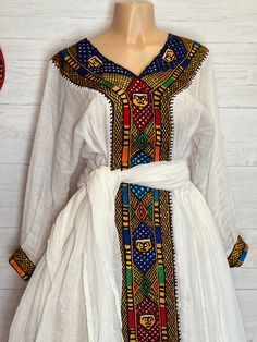 Beautiful Ethiopian and Eritrean Habeshan Dress. Stylish Menen, 100% Cotton We recommend hand washing and air drying to make it last longer. A low heating iron will also keep design and look. Cotton, it doesn't have a pocket. Bohemian Fitted Habesha Kemis For Eid, Festive White Tunic Dress, Bohemian Long Sleeve Habesha Kemis For Festive Occasions, Festive Long Sleeve Habesha Kemis For Festivals, Festive Bohemian Long Sleeve Habesha Kemis, Bohemian Fitted Habesha Kemis For Festivals, Fitted Bohemian Habesha Kemis For Festivals, White Tunic Dress For Traditional Ceremonies, Ceremonial Bohemian Long Sleeve Habesha Kemis