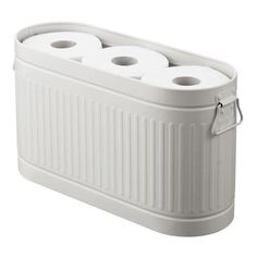 three rolls of toilet paper sitting in a white container with two handles on each side