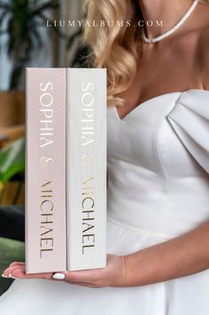 a woman in a white dress holding up two books that read sophia and nichee