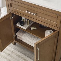 an open drawer in a bathroom next to a sink