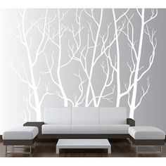 a modern living room with white furniture and trees on the wall, in front of a gray background