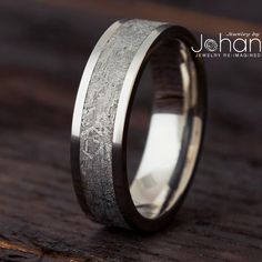 a wedding band that has been made to look like wood and silver inlays