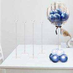 some blue and white balloons are on a table