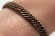 a close up of a person's arm with a bracelet on it