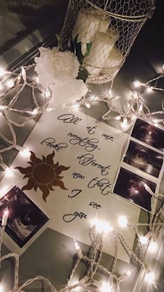 a table topped with pictures and string lights