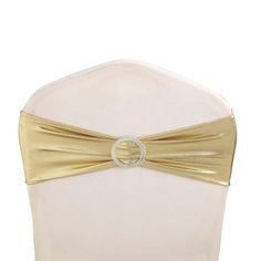 the back of a white chair with a gold bow on it's headband