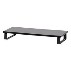 a black coffee table sitting on top of a white wall