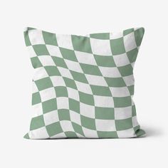 a green and white checkered pillow sitting on top of a table