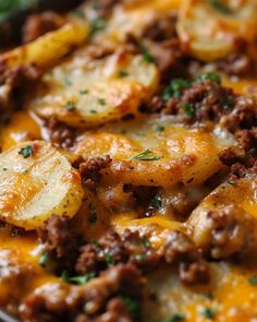 a casserole dish with potatoes, meat and cheese