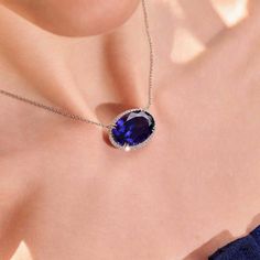 This 25.50 carat oval cut tanzanite sparkles and shines as it's set in 18 karat white gold, surrounded by 0.69 total carats of round brilliant cut diamonds. Reference Code: 30703 Shop other beautiful pieces in our Necklace Collection. For inquiries on the piece please contact: boutique@shsilver.com Luxury Oval Tanzanite Jewelry, Luxury Oval Tanzanite Necklaces, Formal Tanzanite Oval Pendant Jewelry, Paris Ring, Tanzanite Necklace, Tanzanite Jewelry, Halo Necklace, Jewelry Appraisal, Necklace Collection