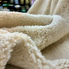 a pile of white towels sitting on top of a table