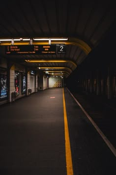 an empty train station at night with no people on the platform or waiting for their trains