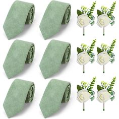 six green ties with white flowers and leaves on them are arranged next to each other