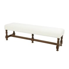 a white bench sitting on top of a wooden frame