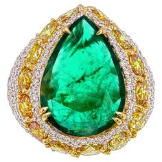 Introducing this GRS Certified 4.95 Carat Zambian Emerald and Diamond Ring, a one-of-a-kind creation that embodies sophistication and exceptional craftsmanship. The centerpiece of this remarkable piece is a 4.95-carat pear-shaped emerald, sourced from the renowned mines of Zambia. Certified by GemResearch SwissLab (GRS) and displaying a natural, untreated beauty with insignificant treatment, this emerald captivates with its deep, rich green hue—an exquisite testament to its origin. What truly makes this ring unique is its innovative design, carefully crafted to highlight the emerald’s elegance. Surrounding the center stone is an intricate arrangement of 4.45 carats of round and fancy-cut diamonds, each precisely placed to enhance the emerald’s natural beauty. The combination of diamond sha Fancy Diamond Ring, Emerald And Diamond Ring, Zambian Emerald, Fancy Diamonds, Zambia, Belleza Natural, Cocktail Rings, Custom Engraving, Unique Rings