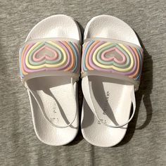 Primark Sandals Has An Elastic Band On The Heel New Without Tags Size 7 Usa Playful Plastic Slip-on Sandals, White Non-slip Flat Jelly Sandals, Non-slip White Flat Jelly Sandals, Playful White Flip Flops For Spring, Playful White Open Toe Flip Flops, Playful White Flat Sandals, Cute White Slip-on Sandals, Playful Non-slip Multicolor Sandals, Playful Non-slip White Sandals