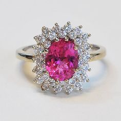 ... ORIGINAL PRICE $2950.00, SALE PRICE $1475.00...This stunning handmade oval pink tourmaline and diamond ring is set in 14k white gold. This ring sparkles a great deal making this a beautiful piece. The two rows of diamonds around the pink tourmaline make for a generous frame that fits this stone magnificently and really shows off its brilliant pink color. This ring would make for a great engagement ring, or right hand ring. Pink Tourmaline: 1.87ct32 Round Brilliant Diamonds: 1 ct VS/G-HRing S Luxury Pink Gemstones For Wedding, Pink Diamond Gemstones With Accents, Luxury Pink Gemstone With Center Stone, Luxury Tourmaline Rings With Halo Setting, Exquisite Pink Sapphire Rings For Formal Events, Elegant Pink Ruby Gemstones, Luxury Pink Oval Sapphire Ring, Pink Gemstones For Formal Occasions, Pink Gemstones For Formal Fine Jewelry