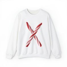 Make a Sweet Statement with our Unisex Candy Cane Letter Crewneck Sweater! Elevate your festive fashion with our Candy Cane Letter Crewneck Sweater. This delightful sweater combines the warmth and comfort you crave during the winter months with a charming, personalized touch. 🍭 Candy Cane Initial: The star of the show is a striking, candy cane-inspired initial letter emblazoned on the front. It's a deliciously festive way to express your unique style and celebrate the holiday season. ❄️ Cozy Co White Graphic Print Sweater For Winter, White Letter Print Sweatshirt For Winter, Winter White Letter Print Sweatshirt, Casual Long Sleeve Holiday Sweatshirt, Casual Holiday Sweater With Graphic Print, Trendy Christmas Long Sleeve Sweater, White Winter Sweatshirt With Graphic Print, Trendy Long Sleeve Christmas Sweater, White Graphic Print Sweatshirt For Winter