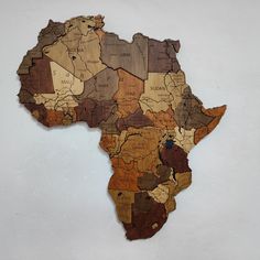 a wooden africa map hanging on the wall