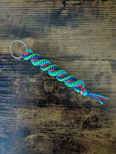 a keychain that has been made to look like a rainbow - colored ribbon