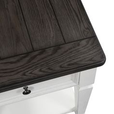 a close up of a wooden table with white legs and dark wood grained top