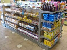 an aisle in a grocery store filled with lots of food and drinks on the shelves