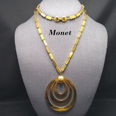 *Description: This is a beautiful Monet necklace, Tournee, a popular pendant necklace from the 1960s. This necklace is featured on page 161 of the Monet The Master Jewelers by Alice Vega. Vega explains that the fashion and accessories of the 1960s were more casual and carefree in feeling. This beautiful box chain pendant necklace is gold plated and has a long length at 29 inches with a large 3 inch pendant. This would be a great addition to your vintage jewelry collection or make a great vintage 70s Jewelry, Monet Necklace, 1960s Jewelry, Book Pieces, Monet Jewelry, Pendant Necklace Gold, Jewelry Lookbook, Funky Jewelry, Brass Necklace